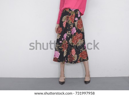 stylish woman in long floral skirt with black shoes fashion concept
