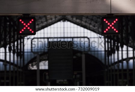 Illuminated red X sign, instructing passengers that it is forbidden to walk in that direction