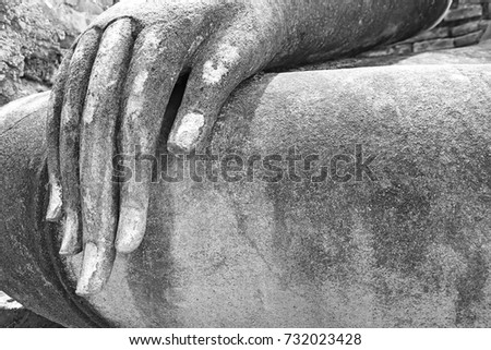 The image of Ancient hand and fingers of Buddhist statues in Thailand. Black and white picture.
