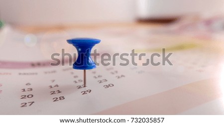 Calendar with blue pin for planning