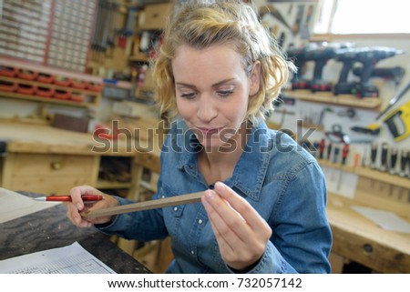 female carpenter works in a workshop