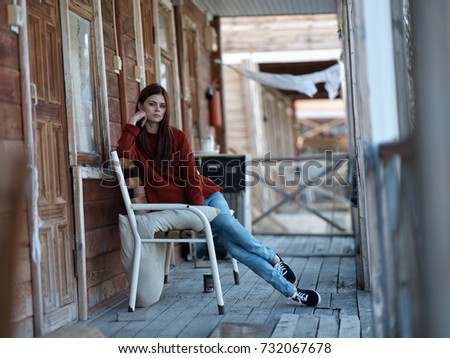 veranda, stylish woman sitting on a chair