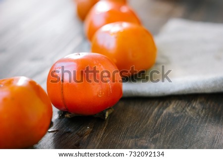Persimmon snake on wooden surface