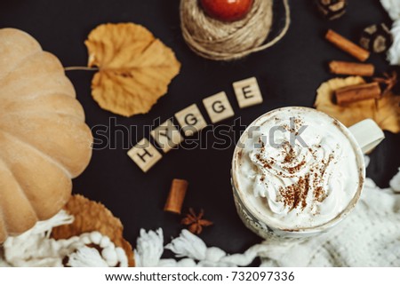 Cozy Autumn Composition. Pumpkin Latte, Cinnamon and plaid on a Black Background