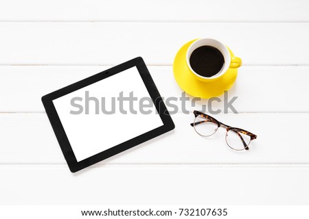 Tablet computer, coffee cup and glasses