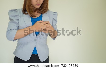  woman holding breast because of heart infarction.
