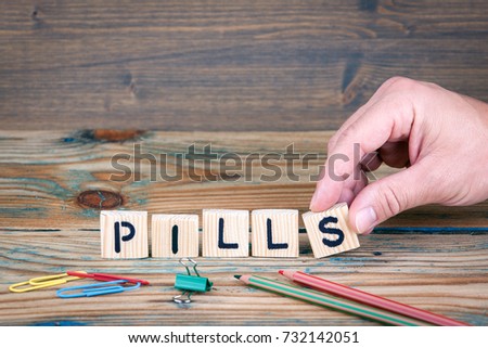 Pills. Wooden letters on the office desk. Healthcare and pharmacy background
