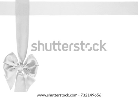 Gift white satin bow on wide cross ribbon on white background