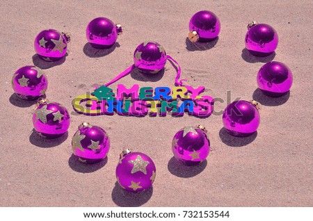 purple christmas ball on the  beach and ocean