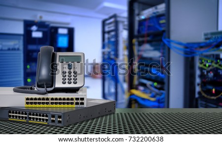 IP Telephone and Network switch 24 port gigabit and 4 port module with Power over Ethernet (PoE) function on port for high speed network in data center room Royalty-Free Stock Photo #732200638