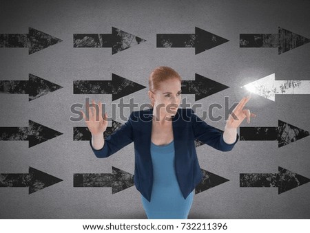 Digital composite of Businesswoman touching glowing arrow in opposite direction