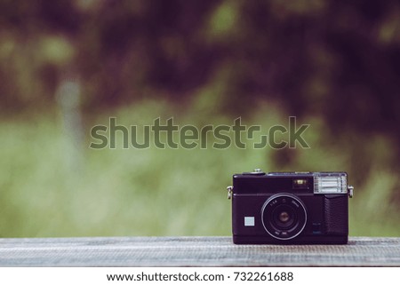 Retro camera and green blur background