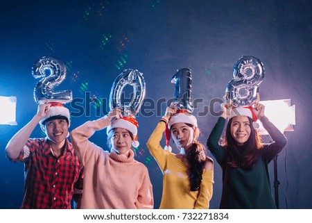 New Year party. Merry Christmas 2018 in nightclub. Friends celebrating together and holding balloon 2018.