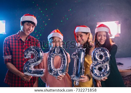 New Year party. Merry Christmas 2018 in nightclub. Friends celebrating together and holding balloon 2018.