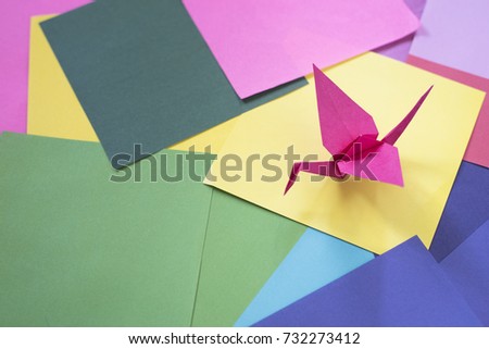 origami on a colorful paper. Origami background. Bird shape origami