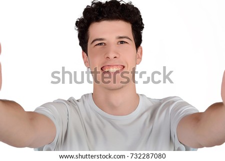 Portrait of a young handsome man taking a selfie. Isolated white background.