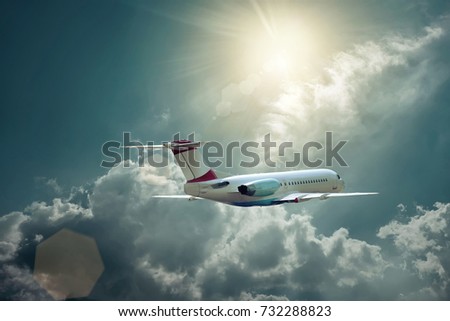Airplane at flying under sky with clouds