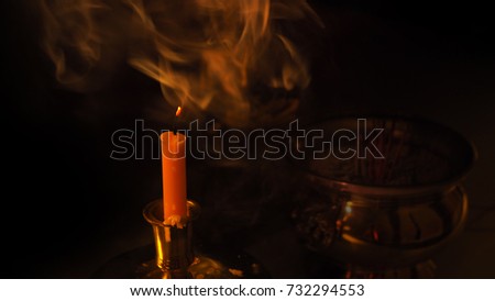 Candle with smoke after praying (selected focus).