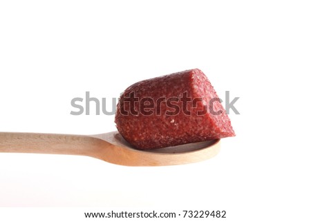 Sausage on a wooden spoon isolated against a white background
