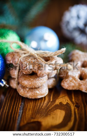 New Year's toys with gingerbread on a wooden background