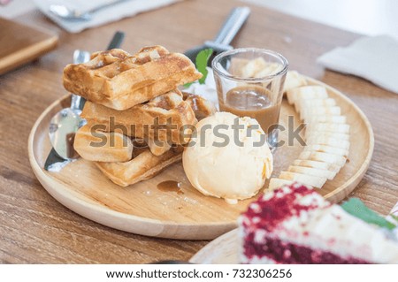 Waffle with ice cream topping with banana slide.