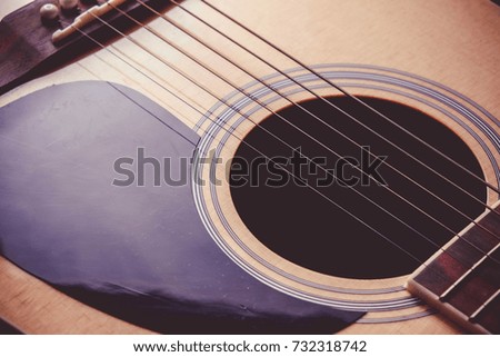 Close Up shot photo of Classic acoustic guitar with filter effect retro vintage style