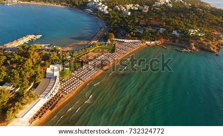 Aerial drone bird's eye photo of famous celebrity sandy beach of Astir or Asteras in south Athens riviera with turquoise clear waters, Vouliagmeni, Greece