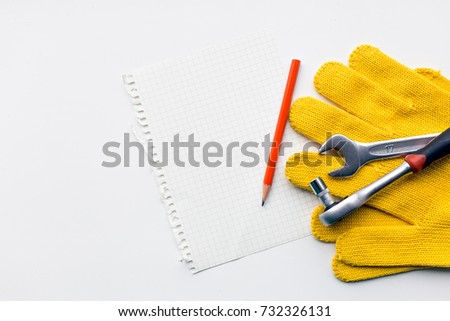 Working gloves and tools on white background