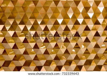 Golden geometric wall made from aluminum sheet. Gold  Polygonal  Background.