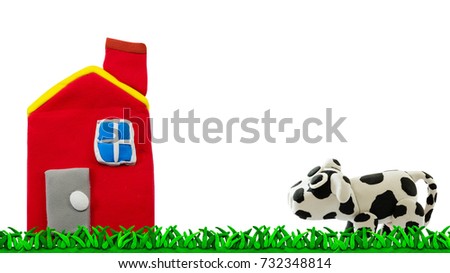 plasticine cow and barn on meadow