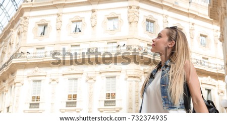 Pretty millennial teenager tourist visiting and doing shopping in the city of Milan, in Italy
