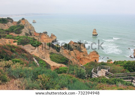 Panoramic Early Morning Landscape, Scenic View with Cliff Rocks and Sea Cost. Vintage style effect image of nature at summer time. Foggy windy weather condition, from top of the rock overlooking water