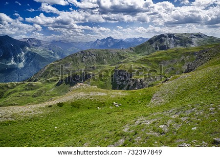 Landscape with pastures and mountains with cloudy sky. Royalty-Free Stock Photo #732397849