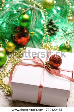 Christmas presents with pink ribbon on white wooden background