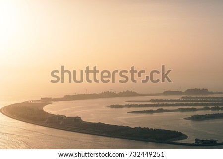 An Artificial Jumeirah Palm Island On Sea Dubai United Arab Emirates, picture at evening making it golden hour.
