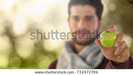Digital composite of Man in Autumn with apple in forest