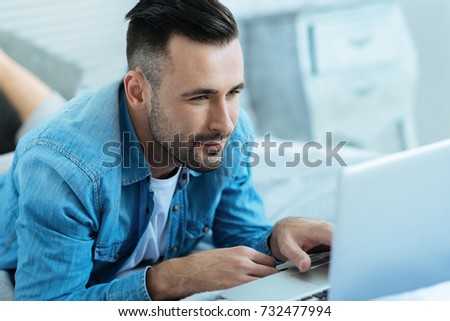 Handsome guy working on laptop at home
