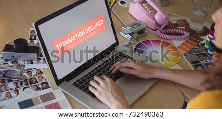 Transaction declined text on display against graphic designer working on laptop at creative office