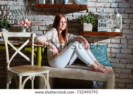 Young woman sitting at vintage home.