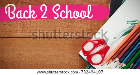 Back to school text against white background against colorful pencils on book