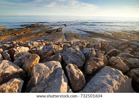 Blue ocean on stone beach. Background.