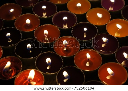 Candles in the darkness; romantic evening in candlelight; light and shadows