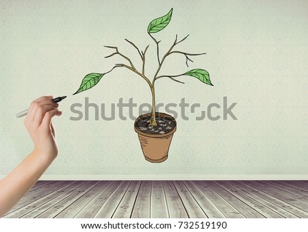 Digital composite of Hand holding pen and Drawing of Plant branches and leaves on wall