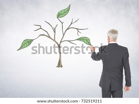 Digital composite of Man holding pen and Drawing of Plant branches and leaves on wall