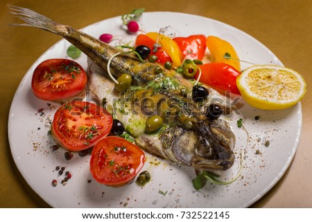 Grilled fish with vegetables. Zander River fish. Restaurant serving. 
