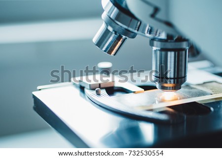 Close-up shot of microscope with metal lens at laboratory. Royalty-Free Stock Photo #732530554