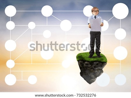 Digital composite of Young boy on floating rock platform  in sky holding card with connectors interface mind map
