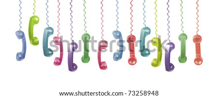 Lots of different coloured old phone handsets are hanging on white background Royalty-Free Stock Photo #73258948