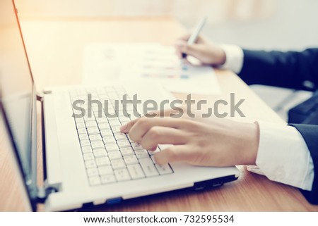 businessman using laptop and analysis many chart graph