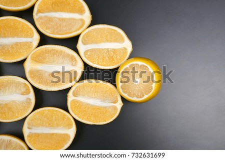 cut in half lemons on a dark background
